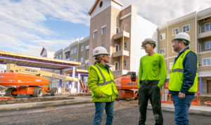 Converse Electric team standing in front of hotel job site