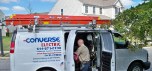 Converse Electric technician getting materials from work van