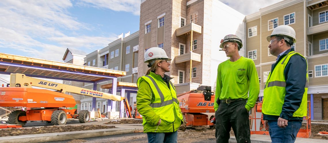 Converse Electric team standing in front of hotel job site