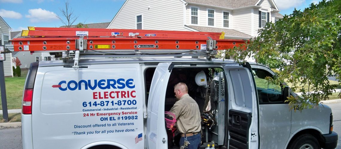 Converse Electric technician getting materials from work van